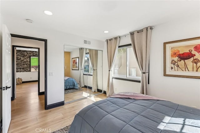 bedroom featuring a closet and light hardwood / wood-style flooring