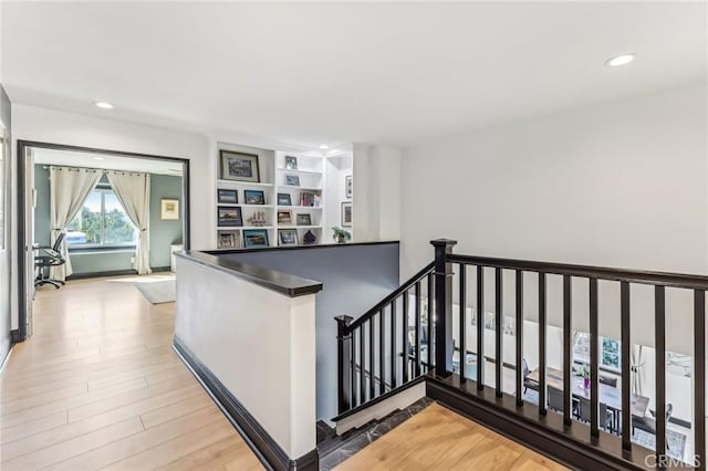 staircase with hardwood / wood-style floors