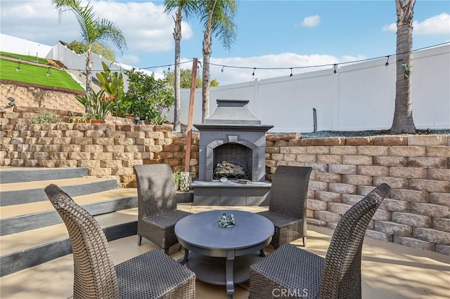 view of patio featuring exterior fireplace