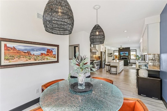 dining area featuring ceiling fan and light hardwood / wood-style floors