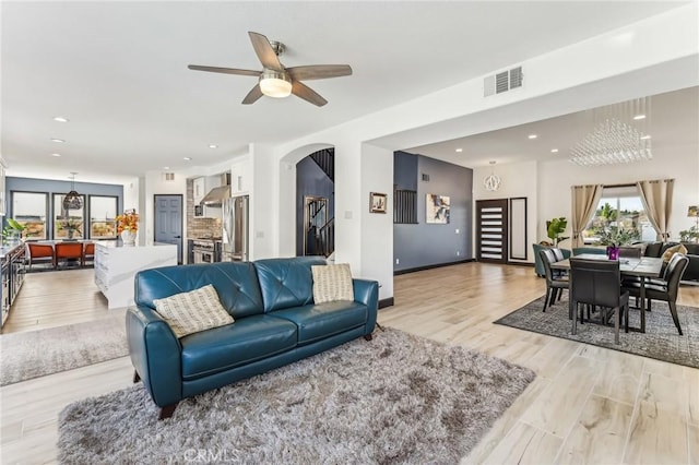 living room featuring ceiling fan and light wood-type flooring