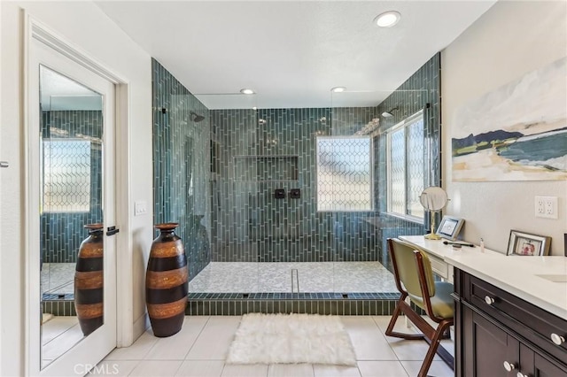 bathroom with tile patterned flooring and tiled shower