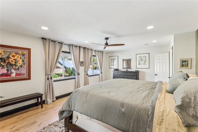 bedroom with ceiling fan and light wood-type flooring