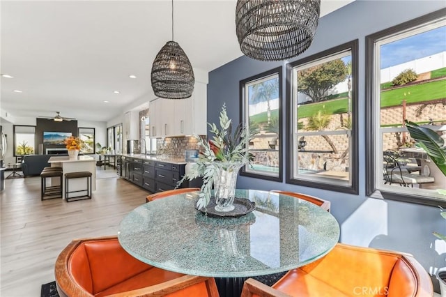 dining area with hardwood / wood-style flooring and ceiling fan