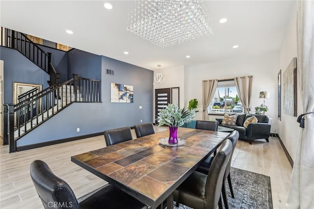 dining room featuring an inviting chandelier and light hardwood / wood-style flooring