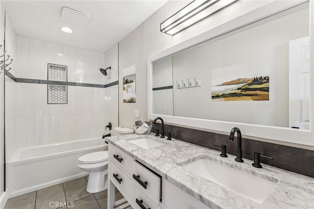 full bathroom with tiled shower / bath combo, vanity, tile patterned flooring, and toilet