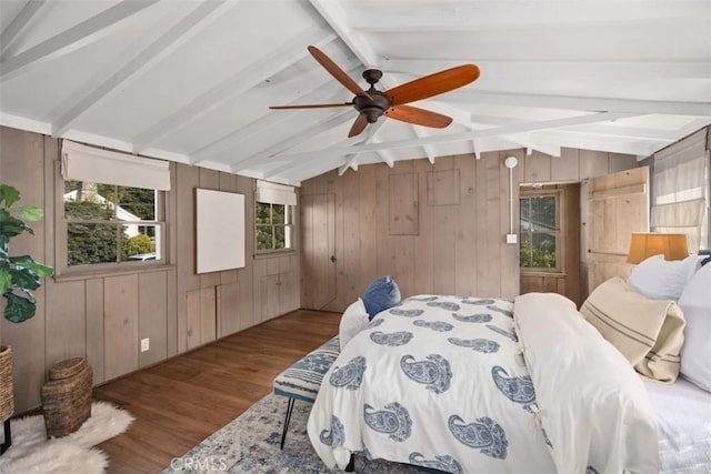 bedroom featuring vaulted ceiling with beams, wood walls, ceiling fan, and wood finished floors