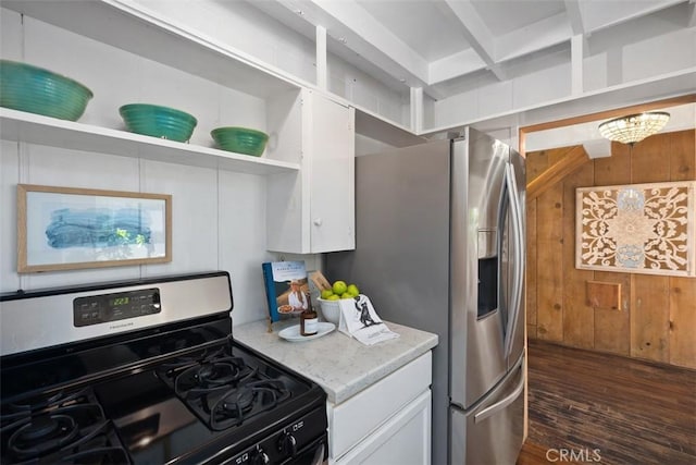 kitchen featuring stainless steel range with gas stovetop, dark wood-style floors, wood walls, and open shelves
