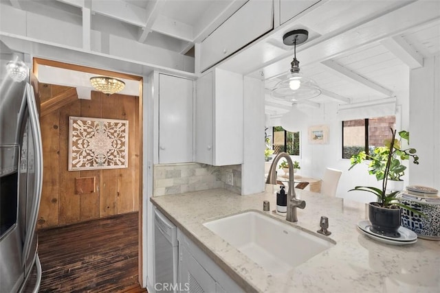 kitchen with stainless steel fridge with ice dispenser, a sink, beam ceiling, and dishwasher