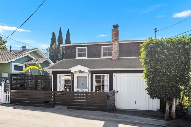 view of front of property with a fenced front yard and a chimney