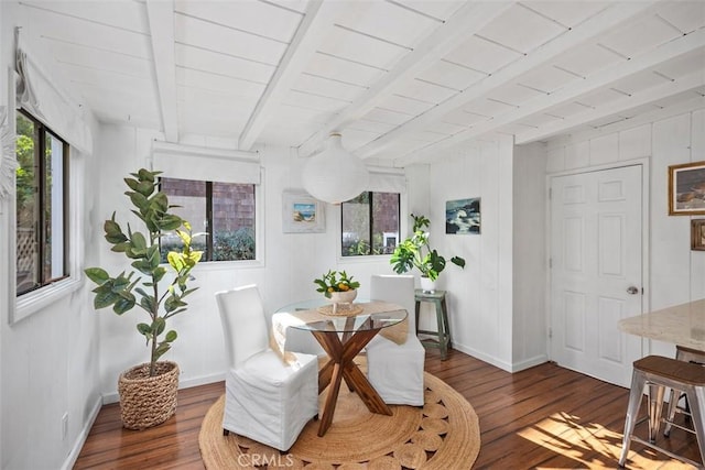 dining area with wood finished floors, beam ceiling, and a healthy amount of sunlight
