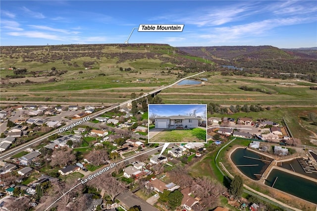 aerial view featuring a water and mountain view and a residential view