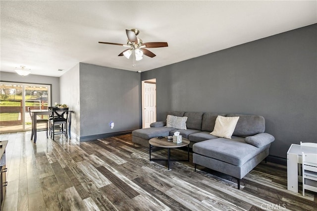 living room featuring wood finished floors, ceiling fan, and baseboards
