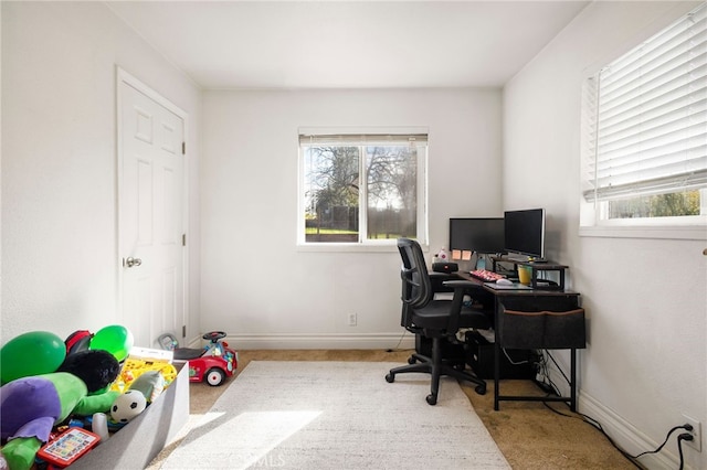 carpeted home office with baseboards and a healthy amount of sunlight