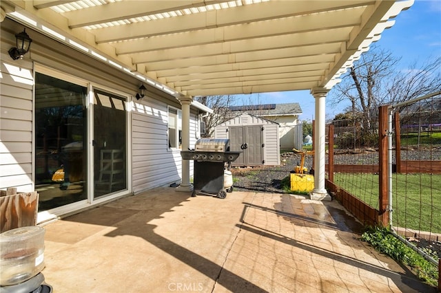 view of patio / terrace featuring area for grilling, a storage unit, and a pergola