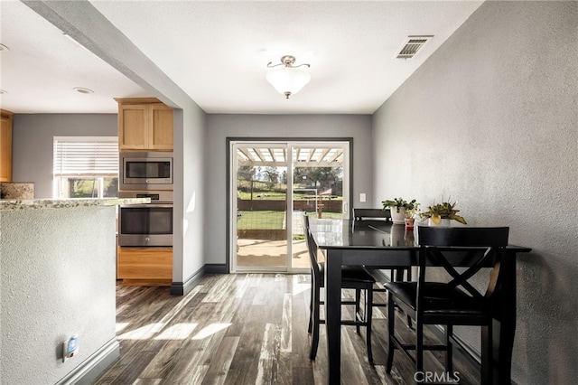 dining area with dark hardwood / wood-style floors