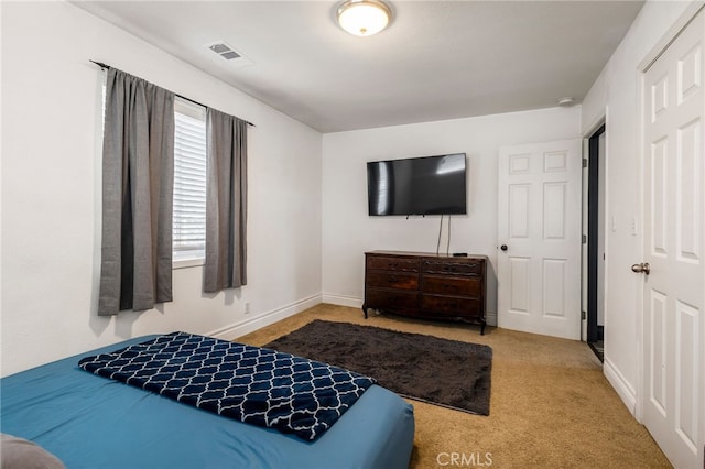bedroom featuring visible vents, baseboards, and carpet
