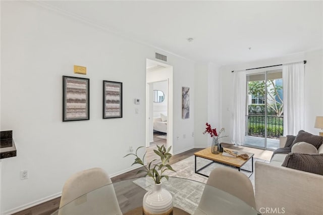 living room with hardwood / wood-style floors and ornamental molding