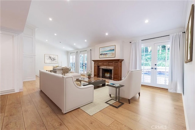 living area featuring light wood-type flooring, a wealth of natural light, and french doors