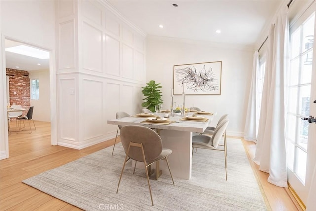 dining space with recessed lighting, light wood-style flooring, and crown molding