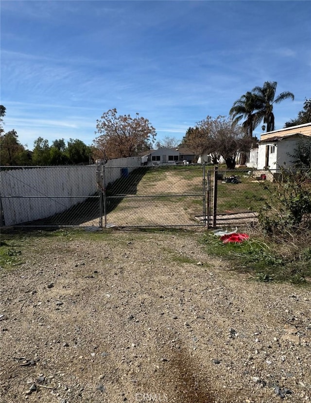 view of yard featuring fence and a gate