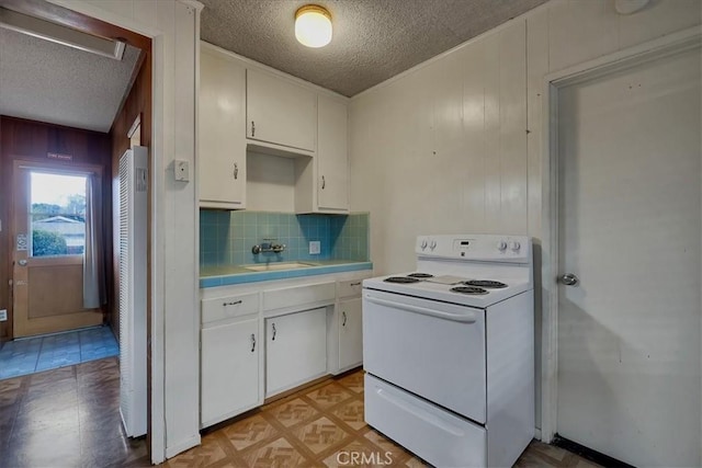 kitchen featuring sink, white cabinets, a textured ceiling, decorative backsplash, and white electric stove