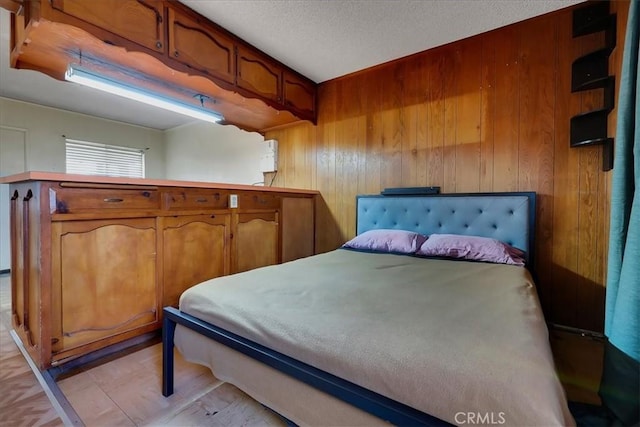 bedroom featuring wooden walls