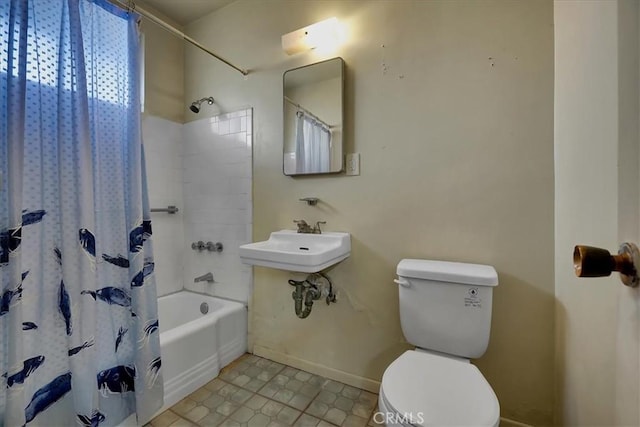 full bathroom featuring sink, shower / bath combination with curtain, and toilet