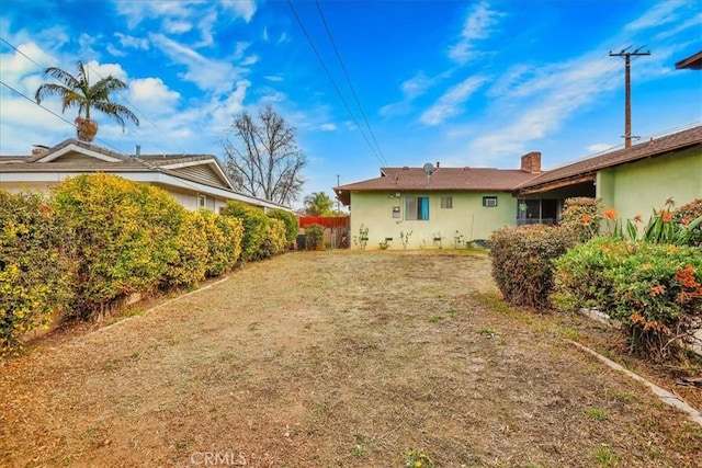 back of property featuring a lawn