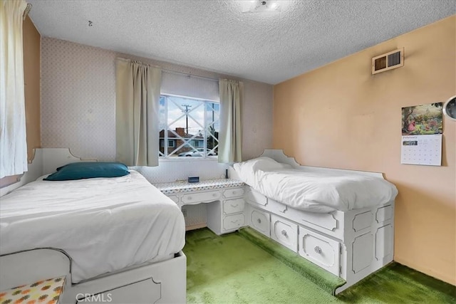 carpeted bedroom featuring a textured ceiling