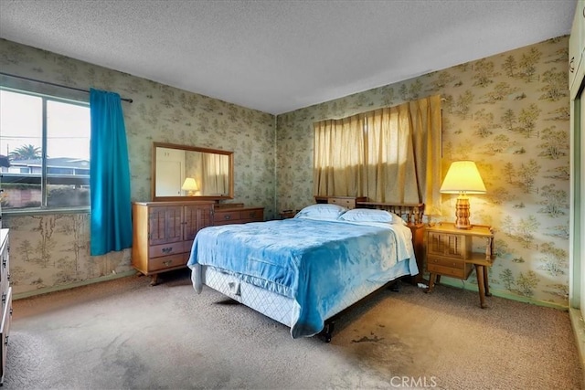 bedroom featuring carpet flooring and a textured ceiling