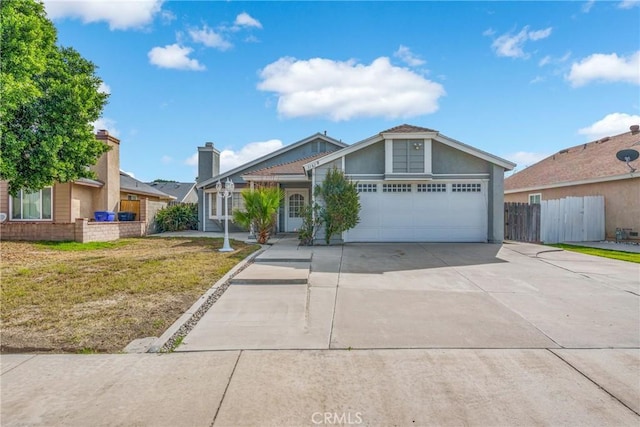 view of front of house with a garage and a front lawn