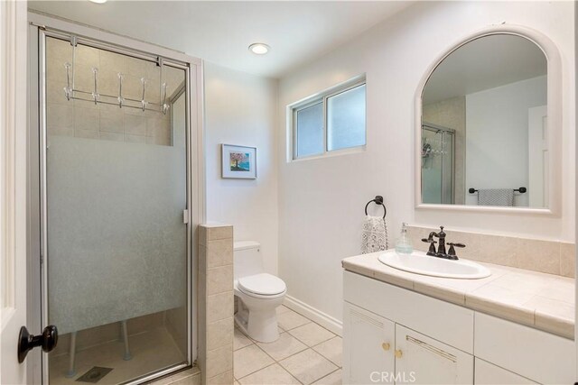 26357 Hillcrest Ave, Lomita, CA 90717 - full bath with vanity, a stall shower, toilet, tile patterned flooring, and baseboards