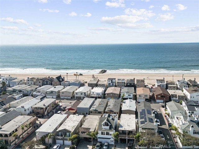 drone / aerial view featuring a water view and a view of the beach