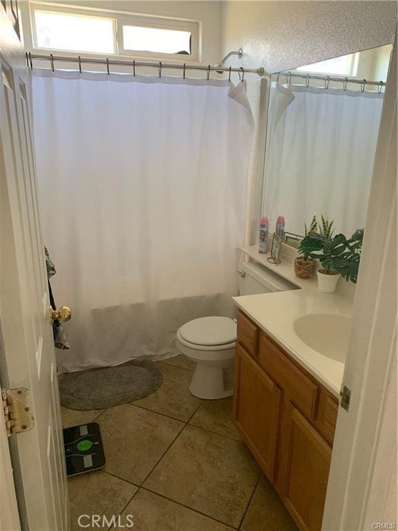 bathroom featuring tile patterned flooring, vanity, and toilet