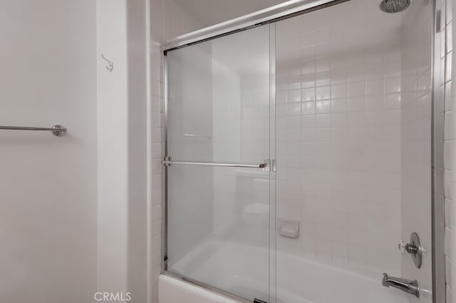 bathroom with shower / bath combination with glass door