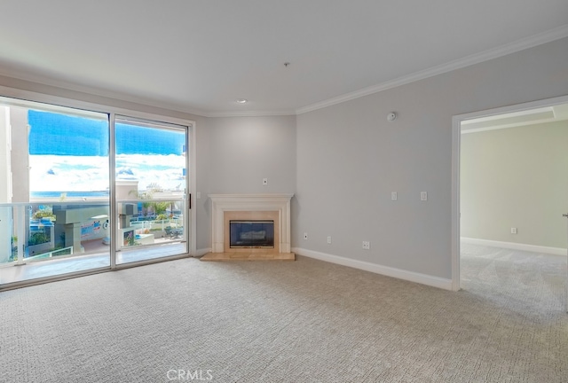 unfurnished living room featuring ornamental molding and light colored carpet