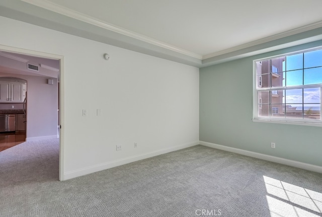 spare room with light colored carpet and ornamental molding