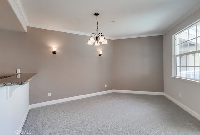 carpeted spare room featuring an inviting chandelier, crown molding, and plenty of natural light