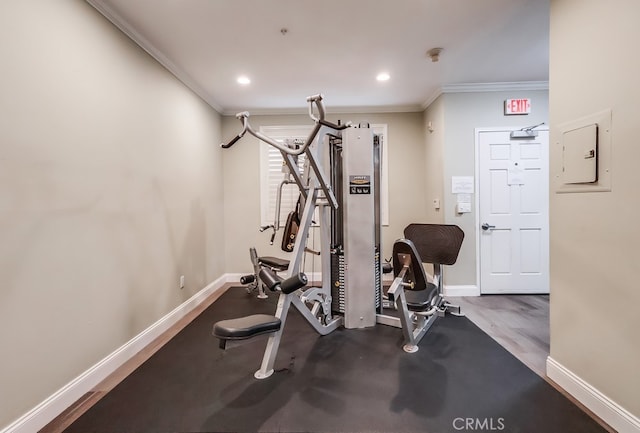 workout room featuring crown molding