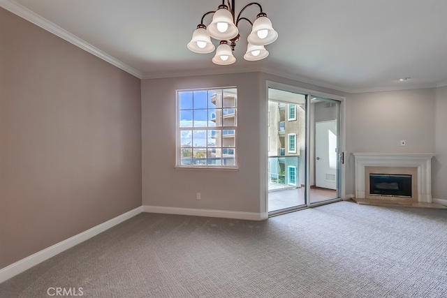 unfurnished living room with an inviting chandelier, carpet floors, and ornamental molding