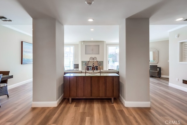 bar with hardwood / wood-style flooring and ornamental molding