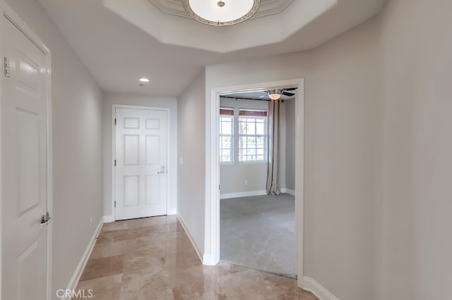 hall with a tray ceiling