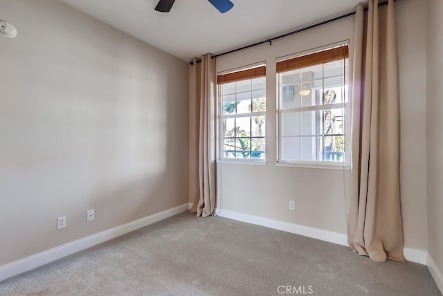 carpeted empty room featuring ceiling fan