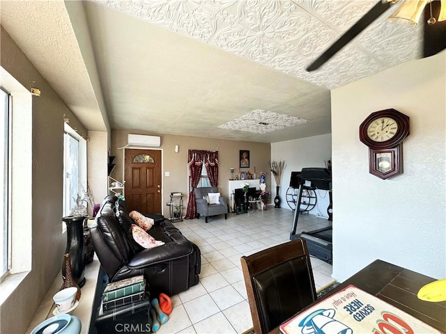 living room featuring a wall mounted AC and light tile patterned flooring