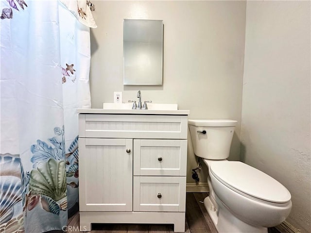 bathroom featuring vanity, hardwood / wood-style floors, and toilet