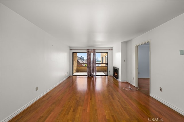 unfurnished living room with dark wood-type flooring