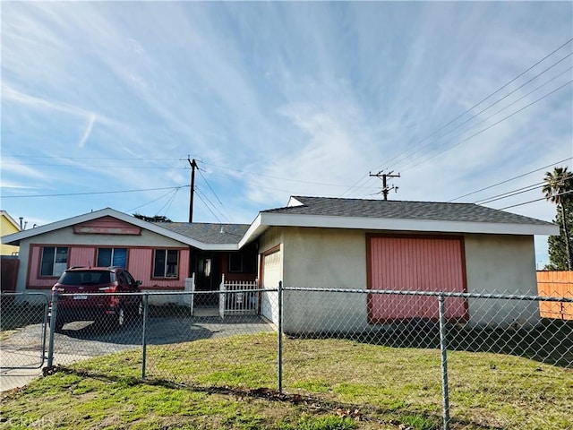 view of front of home with a garage and a front lawn