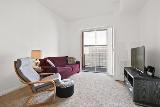 carpeted living room with lofted ceiling