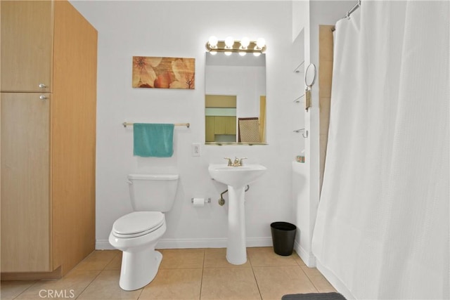 bathroom with a shower with shower curtain, toilet, and tile patterned flooring